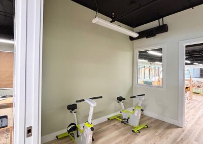 Spacious area with two children's stationary bikes, natural light, and modern décor at The Learning Circle Childcare.