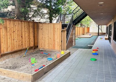 Brightly colored stepping stones and sandpit for children’s outdoor activities.