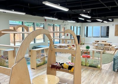 Bright indoor play area with interactive toys and natural lighting at The Learning Circle Childcare.