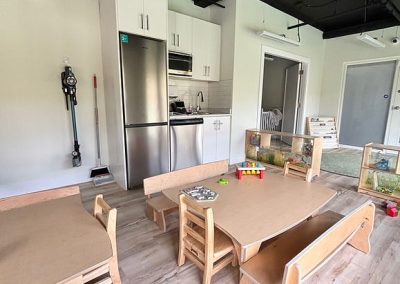 Stylish, family-friendly childcare room with cozy seating and engaging toys.