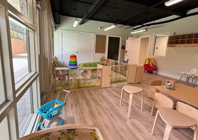 Indoor play area for young children with toys, educational activities, and safe outdoor space.