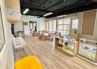Childcare classroom with comfortable seating and learning activities for young children.
