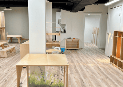 Spacious interior of The Learning Circle Childcare featuring natural wood furniture and open play areas.