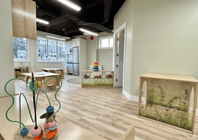 Bright indoor playroom with child-friendly furniture, educational toys, and natural light.