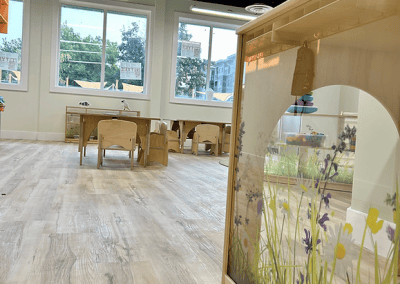 Spacious, inviting early childhood learning environment with colorful decorations and play areas.