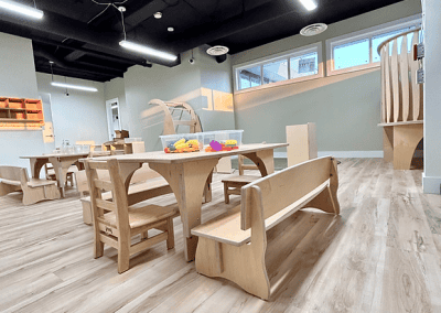 Bright, welcoming childcare center with playful and educational wooden furniture.