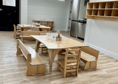 Child-friendly classroom at The Learning Circle Childcare featuring wooden furniture, a clean design, and a cozy learning environment.